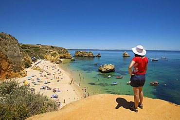 Woman overlooking Praia Dona Ana near Lagos, Algarve, Portugal, Europe