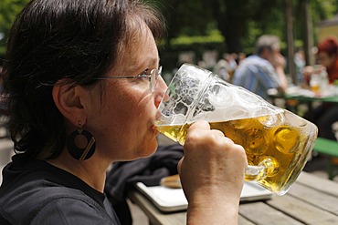 Woman drinking a litre of Spaten brand beer, Taxisgarten Beer Garden, Munich, Bavaria, Germany, Europe