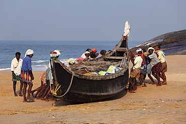 Fishermen pulling their boat on a beach south of Kovalam, Malabar Coast, Malabar, Kerala, southern India, India, Asia