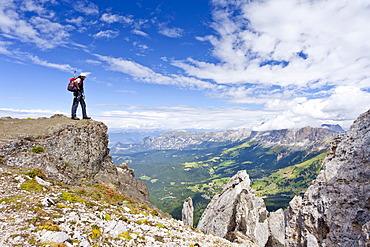 Hikers at the Latemar crossing, fixed rope route, Rosengarten group at back, Dolomites mountain range, South Tyrol, Italy, Europe