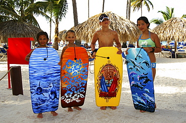 Children with their surfboards on the beach in Punta Cana, Dominican Republic, Caribbean, Americas