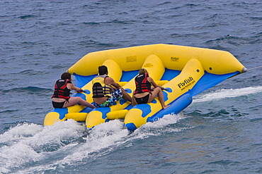 Young people on a fun boat off the beach of the Promenade des Anglais in Nice, CÃ´te d\'Azur, Southern France, France, Europe