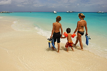 Woman and two children on the beach, Laguna Resort, The Maldives, Indian Ocean