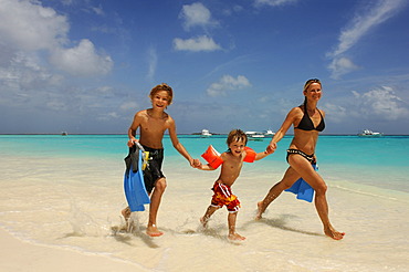 Woman with two children on the beach, Laguna Resort, The Maldives, Indian Ocean