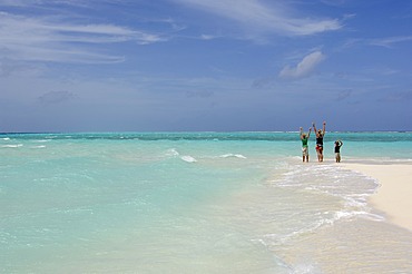 Woman and two children on the beach, Laguna Resort, The Maldives, Indian Ocean