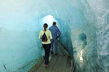 Hikers in a glacier cave, Rhone Glacier, Furka Pass, Uri, Switzerland, Europe