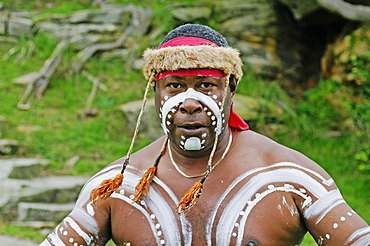 Painted Aborigine performing an Aboriginal dance during the Aboriginal Cultural Cruise in the port of Sydney, New South Wales, Australia