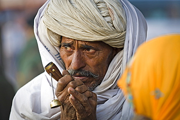 Man wearing a white turban with a chilam pipe, portrait, Jaipur, Rajasthan, India, Asia