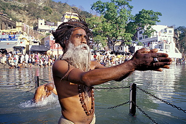 Sadhu during a Hindu morning prayer in the Ganges River, Puja, Kumbh or Kumbha Mela, Har Ki Pauri Ghat, a famous bathing ghat at Haridwar or Hardwar, Uttarakhand, formerly Uttaranchal, North India, India, Asia