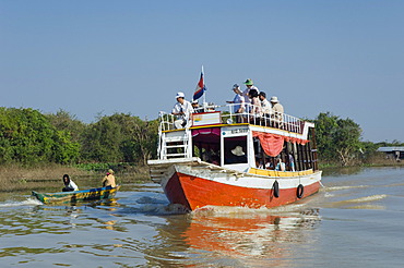 Tourist excursion boat on the Tonle Sap Lake, Chong Khneas floating village, Siem Reap, Cambodia, Indochina, Southeast Asia