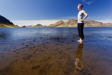 Young woman reflected in Lake âˆšÃ…lftavatn, Laugavegur, Iceland, Europe