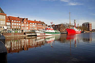 Museum ships are reflected in the water of the Ratsdelft in the harbour of Emden, East Frisia, Lower Saxony, Germany