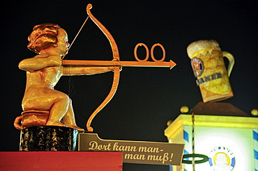 Cupid with bow and arrow pointing towards the toilet, Oktoberfest festival, Munich, Upper Bavaria, Bavaria, Germany, Europe