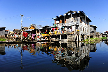 Stilt houses with reflections on Lake Inle, Burma also known as Myanmar, Southeast Asia, Asia