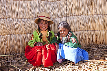 Two young girls, floating Uro Island, Lake Titicaca, Puno, Peru, South America