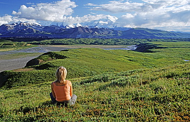 Woman enjoying evening sun, Mt. McKinley in background, Denali National Park, Alaska, USA