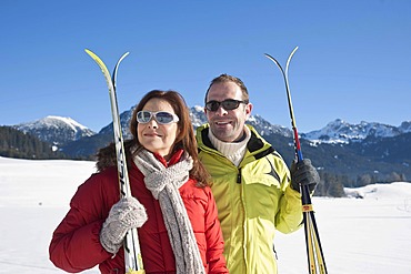 Couple with cross-country skis in the mountains