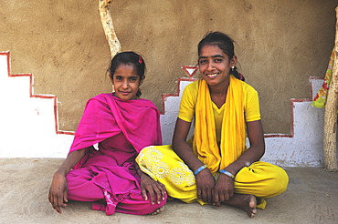 Children sitting in front of a traditional house, Thar Desert, Rajasthan, India, Asia