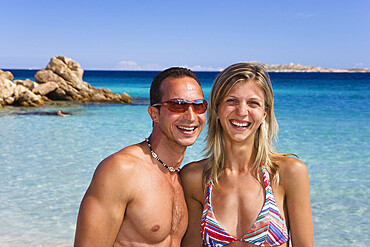 Couple, about 30 years old, on Spiaggia Capriccioli beach, coast, Sardinia, Italy, Europe