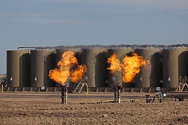 Natural gas is flared off as oil is pumped in the Bakken shale formation; the gas is burned because no pipelines have been built to transport it to market, Watford City, North Dakota, United States, North America