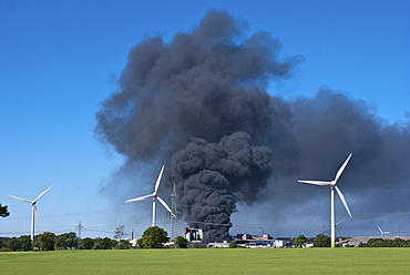 Major fire at waste recycling plant in the industrial area behind wind turbines, Melbeck, Lower Saxony, Germany, Europe