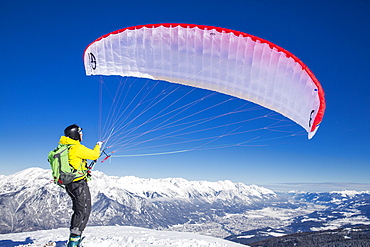 Paraglider, man preparing glider for takeoff, Axamer Lizum, Innsbruck, Tyrol, Austria, Europe