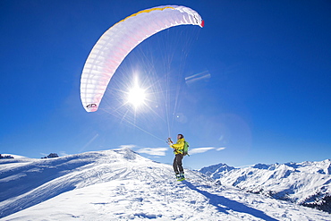 Paraglider, man preparing glider for takeoff, Axamer Lizum, Innsbruck, Tyrol, Austria, Europe