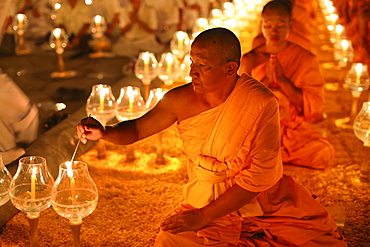 Monk lights candle, meditation, Wat Phra Dhammakaya Temple, Khlong Luang District, Pathum Thani, Bangkok, Thailand, Asia