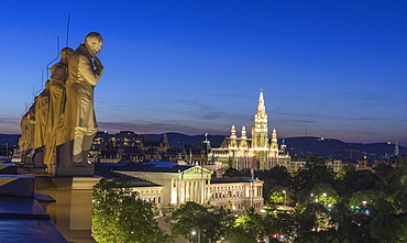 Statues of famous scientists on the roof of the Natural History Museum at night, view of Parliament and the City Hall, Vienna, Austria, Europe