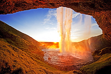 Seljalandsfoss waterfall in the back light, Seljalandsa river, South Island, Island