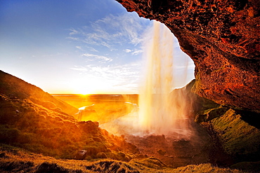 Seljalandsfoss waterfall in the back light, Seljalandsa river, South Island, Island