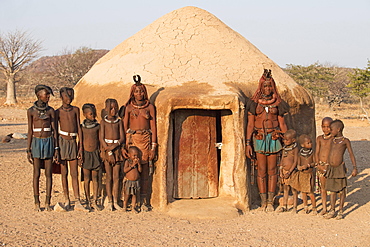 Himba women with children in front of a sleeping hut, Kaokoveld, Namibia, Africa