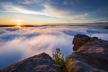 Thick fog is filling the valley of the river Elbe in Elbsandsteingebirge, seen from Lilienstein at sunrise, Konigstein, Saxony, Germany, Europe