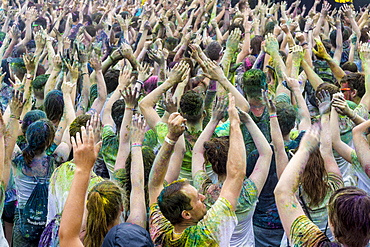 Thousands of young women and man are raising their arms at the colorful Holi festival, Dresden, Saxony, Germany, Europe