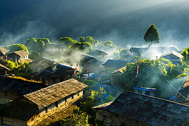 View on village in morning light, smoke is coming out of the houses, Ghandruk, Kaski District, Nepal, Asia