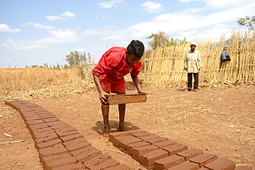 Teenager manufacturing bricks, Analakely village, Tanambao commune, Tsiroanomandidy district, Bongolava region, Madagascar, Africa