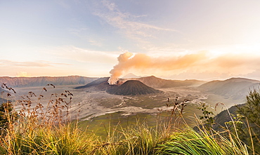 Sunrise, smoking volcano, Gunung Bromo, Mount Batok, Mount Kursi, Mount Semeru, Bromo Tengger Semeru National Park, Java, Indonesia, Asia