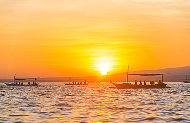 Sunrise, outrigger canoes in the sea, Lovina Beach, Bali, Indonesia, Asia