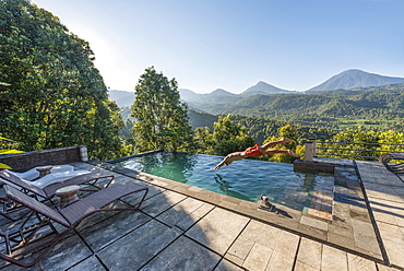 Man jumps into a swimming pool, Munduk, Bali, Indonesia, Asia