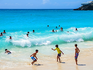 Tourists bathing in high waves at Maho Beach, Simson Bay Village, Philippsburg, Caribbean, Sint Maarten, North America