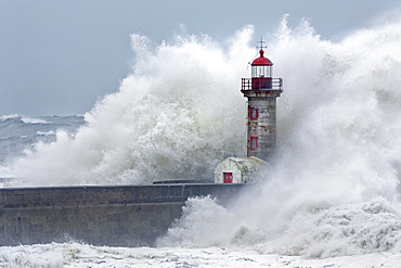 High waves, splashing spray, lighthouse during storm, Porto, Portugal, Europe