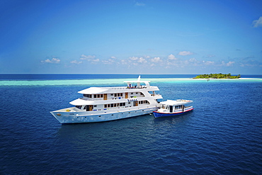 Diving safari ship MS Keana with diving dhoni anchored off an uninhabited palm island, Ari Atoll, Indian Ocean, Maldives, Asia