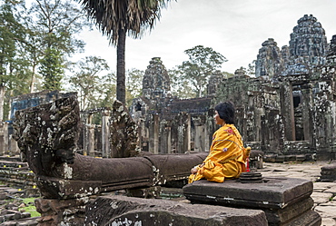 Woman meditates at Bayon Temple, Angkor Thom, Cambodia, Asia