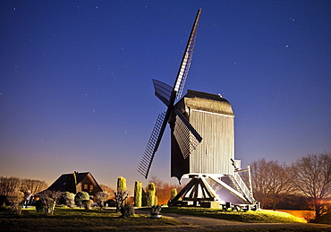 Illuminated Kastenbockwindmühle, historical windmill, with starry sky, Tönisberg, Kempen, Lower Rhine, North Rhine-Westphalia, Germany, Europe