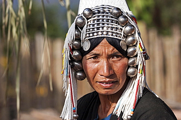 Old local woman from the tribe of the Akha with typical headdress, portrait, Hokyin Akha Village, near Kyaing Tong, Shan State, Golden Triangle, Myanmar, Asia