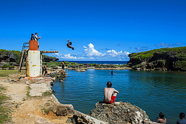 Local boys jumping and swimming in the Salugula Pool, Guam, US Territory, Pacific, Oceania