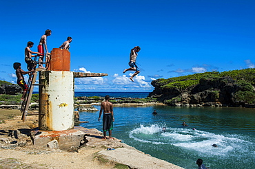 Local boys jumping and swimming in the Salugula Pool, Guam, US Territory, Pacific, Oceania