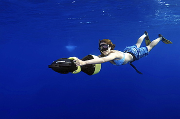 Freediver diving with underwater scooter, Red Sea, Egypt, Africa