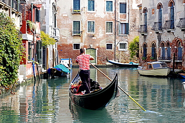 Gondola with gondolier using cell phone, Dorsoduro, Venice, Veneto, Italy, Europe