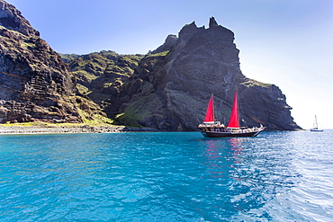 Sailing ship with red sails in a small bay near Los Gigantes, Santiago del Teide, Tenerife, Canary Islands, Spain, Europe